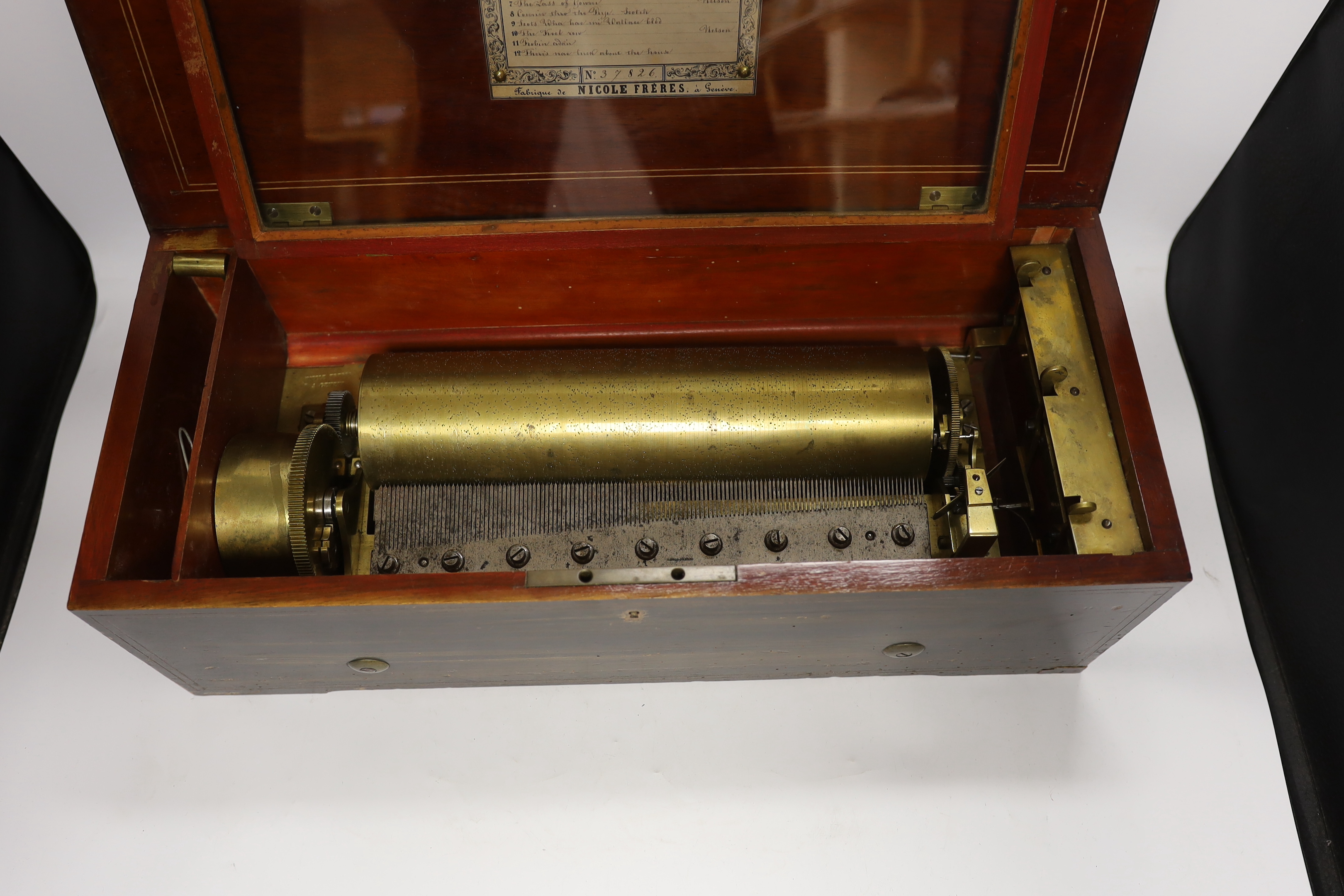A late 19th century Swiss rosewood inlaid cylinder music box by Nicole Freres, playing twelve airs on one hundred and twenty-nine teeth, barrel 31cm wide, case 53cm wide, 22.5cm deep, 17cm high